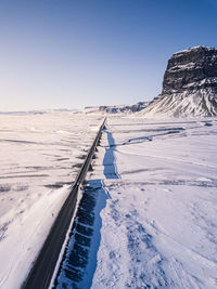 Scenic view of snow covered mountain against clear sky