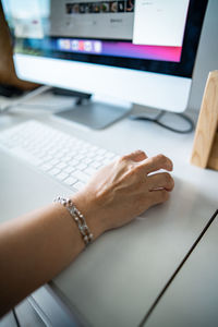 Closeup of woman's hand clicking mouse. working at home.