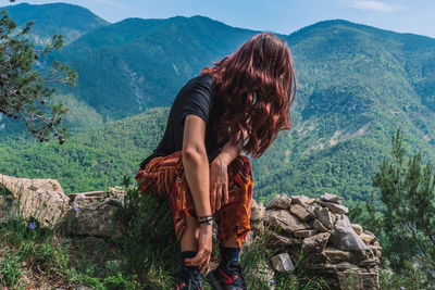 Woman looking at mountain range