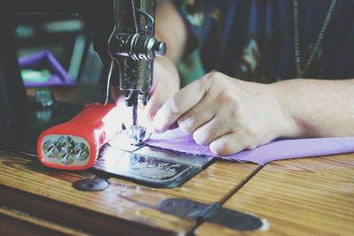 Midsection of man working on table