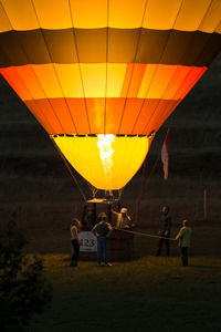 People in hot air balloons at sunset