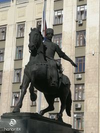 Low angle view of statue against building