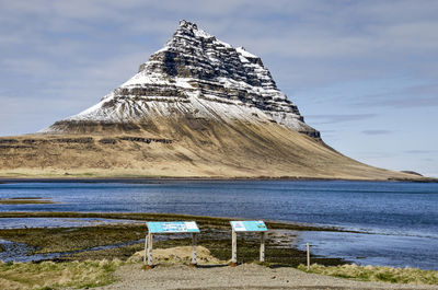 Information panels along the coastal road, with the iconic kirkjufell mountainin the background