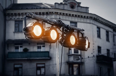 Street spotlight. four round glowing lamps. lighting of streets, objects, buildings. evening