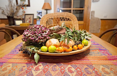 Fruits in basket on table at home