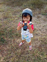 Full length of cute baby girl on field