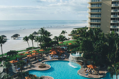 High angle view of hotel with swimming pool by beach