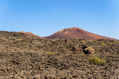 Scenic view of arid landscape against clear sky