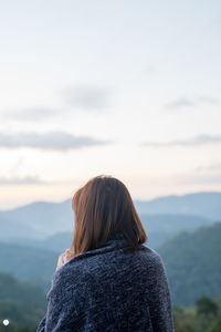 Solo woman drink coffee with relax and wellbeing feel with mountain background