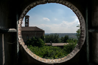 House and trees seen through window