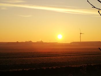 Scenic view of field against sky during sunset