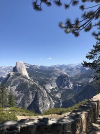 Scenic view of mountains against clear blue sky