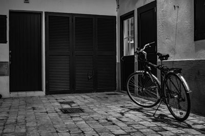 Bicycle on street against building