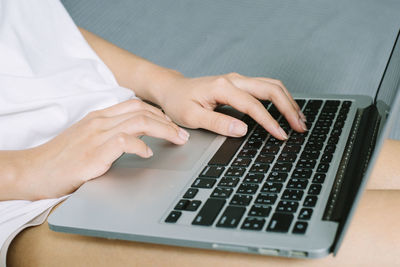 Midsection of woman using mobile phone