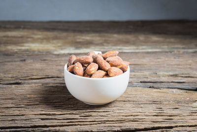 Close-up of salted almonds in bowl on table