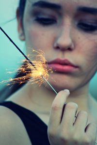 Midsection of woman holding sparkler