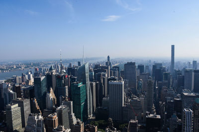 Bank of america building amidst skyscrapers in city against sky