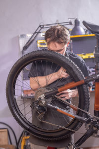 Man with bicycle on wall