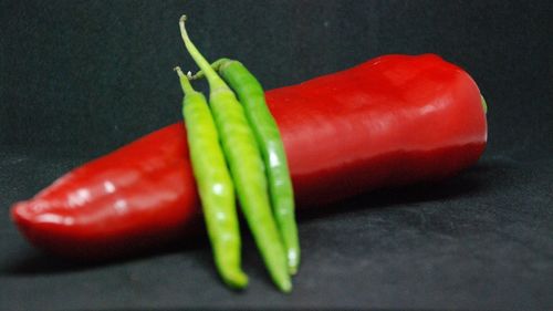 Close-up of red chili peppers on table