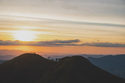 Scenic view of silhouette mountains against sky during sunset