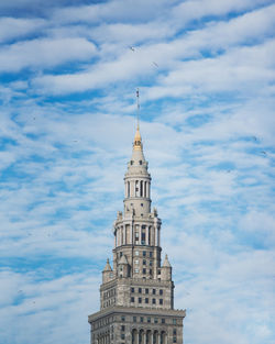 Low angle view of building against cloudy sky