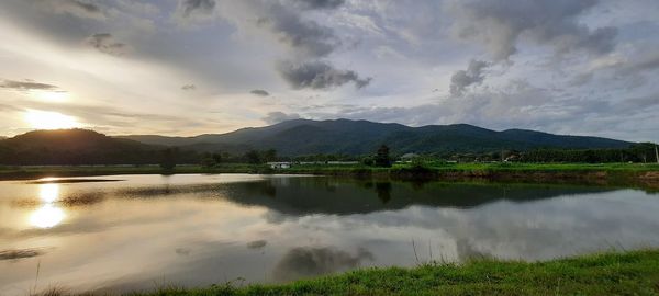 Scenic view of lake and mountains against sky
