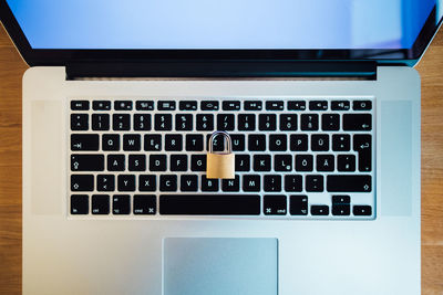 Close-up of padlock on laptop at table