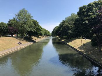 River amidst trees against sky