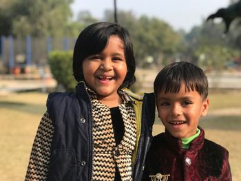 Portrait of smiling friends at public park