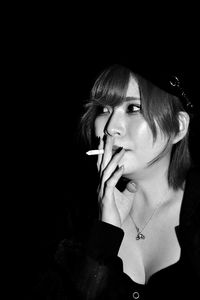 Portrait of young woman smoking cigarette