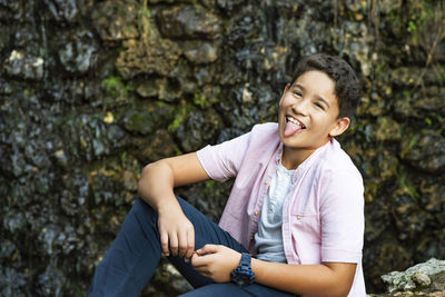 Smiling boy sitting outdoors