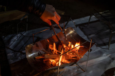 Reflection of person with fire on barbecue grill