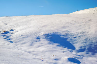 Scenic view of snowcapped mountains against clear blue sky