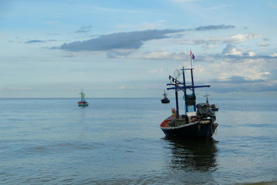 Boat sailing in sea against sky