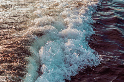 High angle view of waves splashing on sea