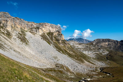 Scenic view of mountains against blue sky