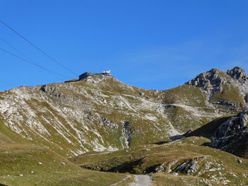 Scenic view of snowcapped mountains against clear blue sky