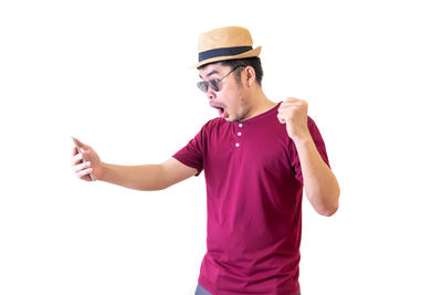 Young man wearing hat standing against white background