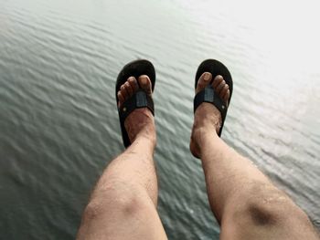 Low section of man legs in sea