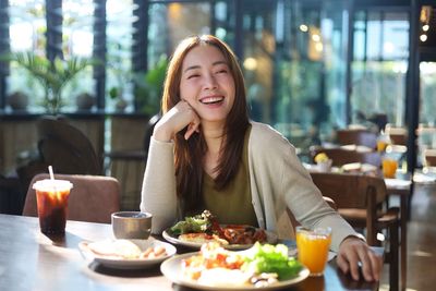 Portrait of young woman sitting at restaurant