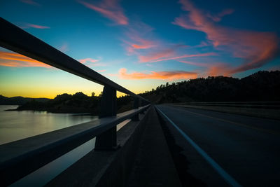 Silhouette bridge against sky during sunset