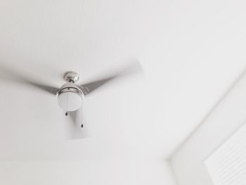 Close-up of electric lamp hanging on ceiling