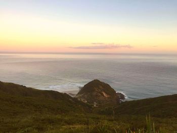 Scenic view of sea and mountains during sunset