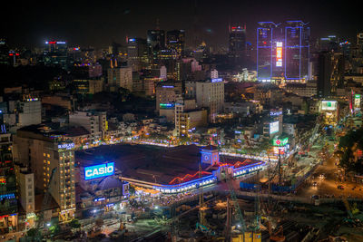 High angle view of illuminated buildings in city at night