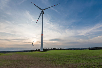 Windmill on field against sky