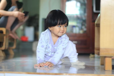 Cute girl sitting at table at home