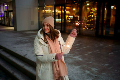 Caucasian white girl with sparklers christmas shopping