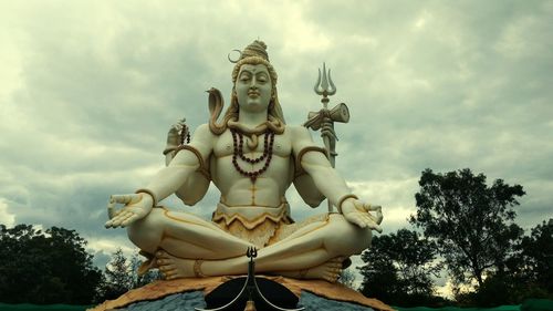 Low angle view of statue against cloudy sky