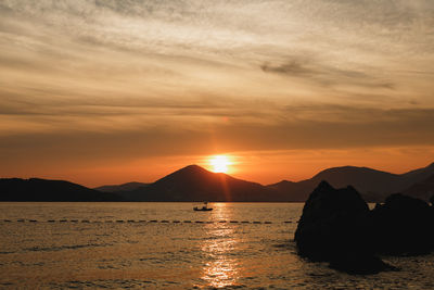 Scenic view of sea against romantic sky at sunset