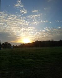 Scenic view of field against sky during sunset